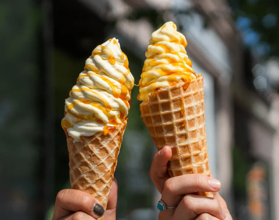 Two soft-serve cones with real-fruit drizzle